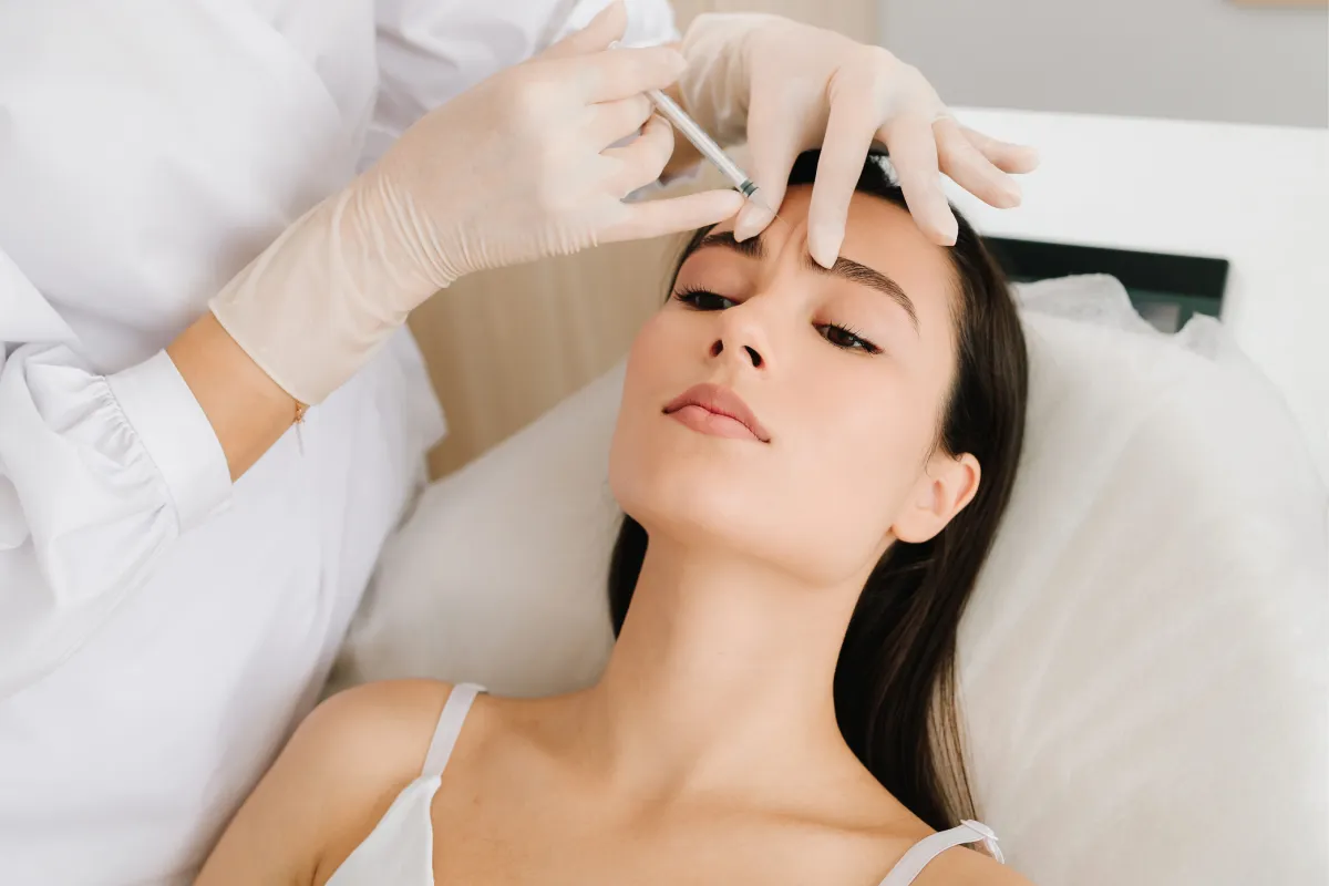 Woman receiving Jeuveau injection in upper forehead area at Belle Piel Aesthetics
